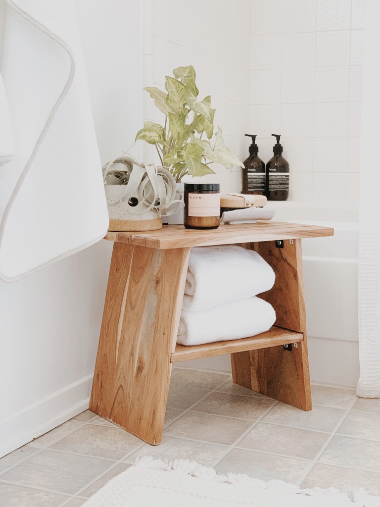 Image of bathroom stool organized with towel and bath essentials