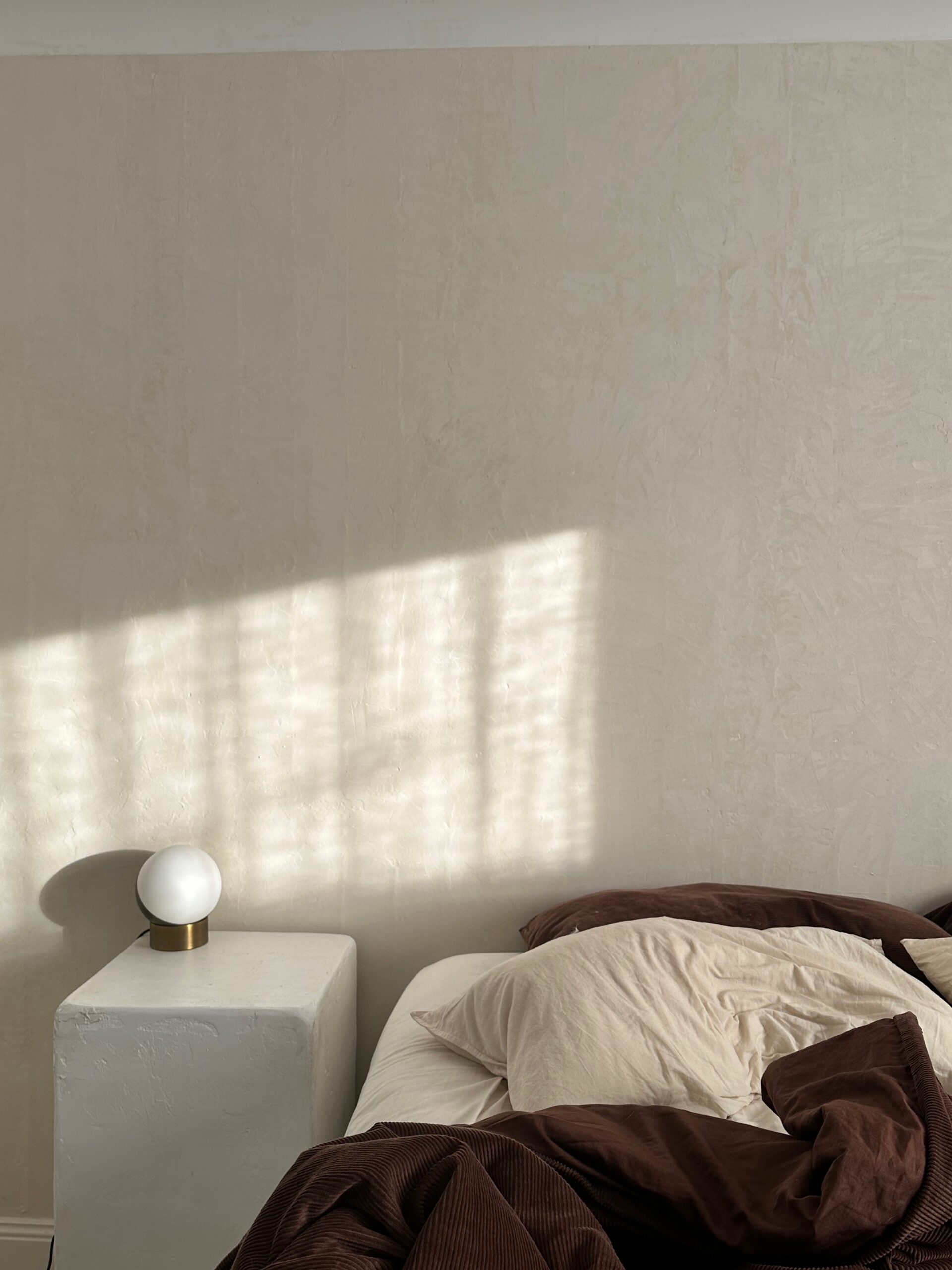 Morning light shines into a soft bedroom as part of a morning routine add on